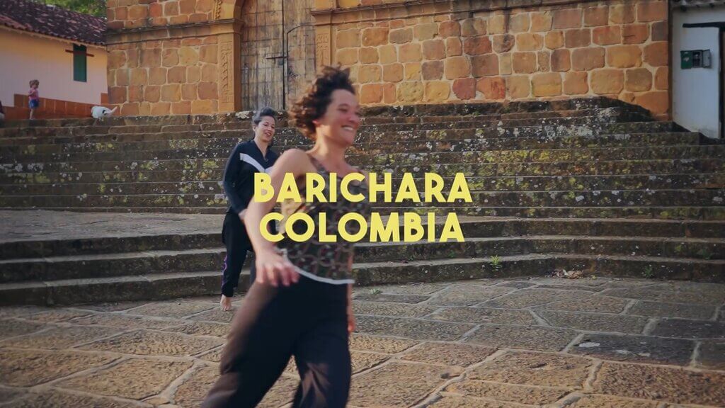 Two women dancing in Barichara, Colombia. Text overlay: "BARICHARA COLOMBIA