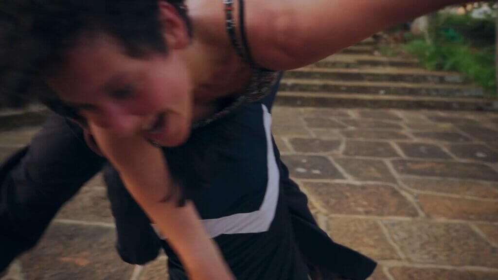 Woman carrying another on her back on stone steps, out of focus.