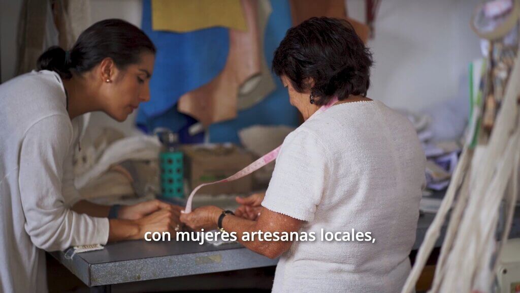 Two women, one holding a measuring tape. Zuahaza collaboration.