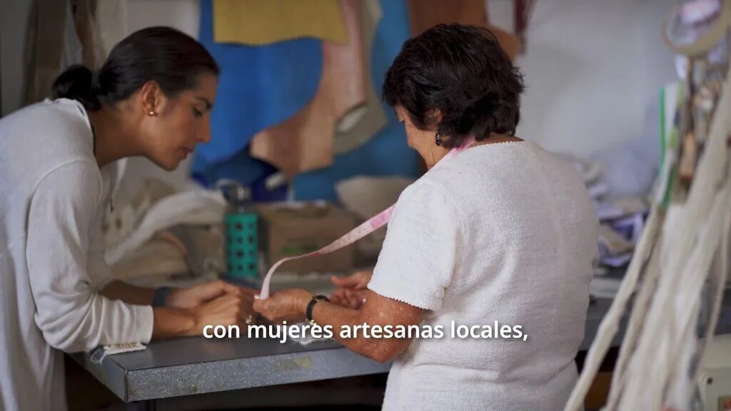 Two women, one holding a measuring tape. Zuahaza collaboration.