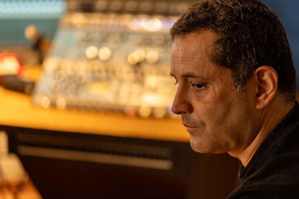 Man in recording studio with audio mixing console. Euforia.