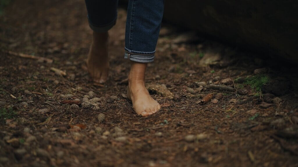 Barefoot walking on a forest floor. Shinrinyoku with nature.