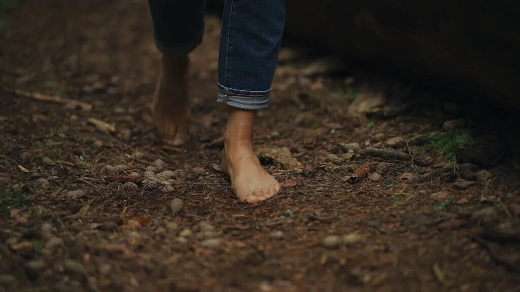 Barefoot walking on a forest floor. Shinrinyoku with nature.